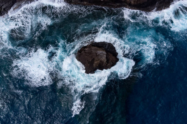 istock Top Down Aerial View Waves Crashing on Rocks 1454196977