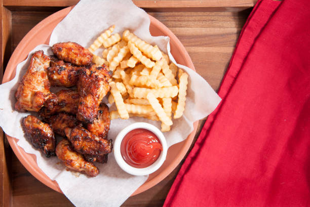istock chicken wings and fries 1454197831