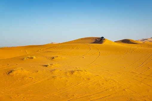 Doha, Qatar - April 20, 2022: Car racing at sand dune is a very poplar activity among tourists in Doha.