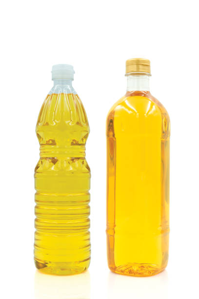 istock Vegetable oil cooking in plastic clear bottle with lid isolated on white background. 1454199835
