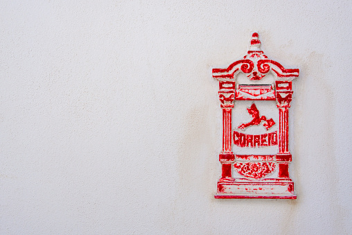 Antique Portuguese mailbox in a white wall.