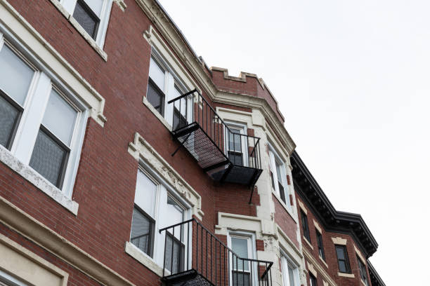 istock Elaborate architectural details on windows, overhangs, and top edge of a classic urban apartment building, metal balconies 1454205209