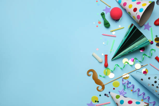 istock Flat lay composition with party hats and other festive items on light blue background, space for text. Birthday surprise 1454205589