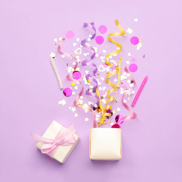 istock Beautiful flat lay composition with gift box and festive items on violet background. Surprise party concept 1454205666