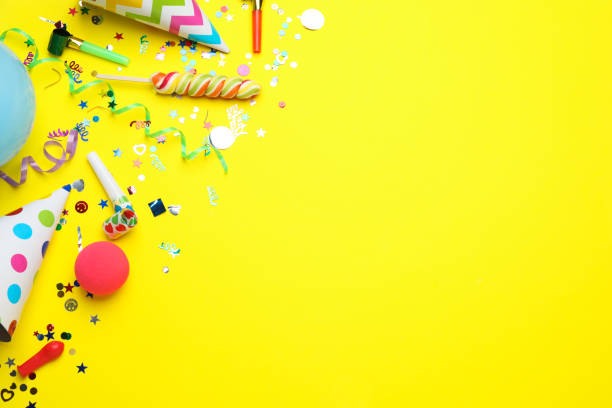 istock Flat lay composition with party hats and other festive items on yellow background, space for text. Birthday surprise 1454206361