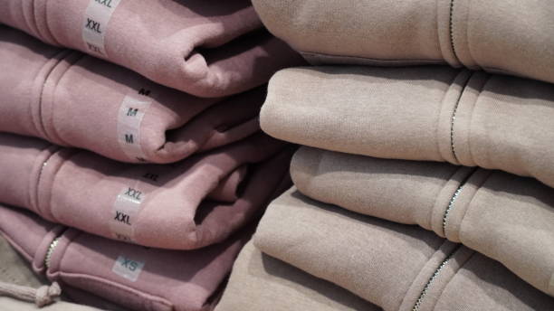 istock Stack of cloth different colors and sizes on the shelves in a clothes store 1454208382