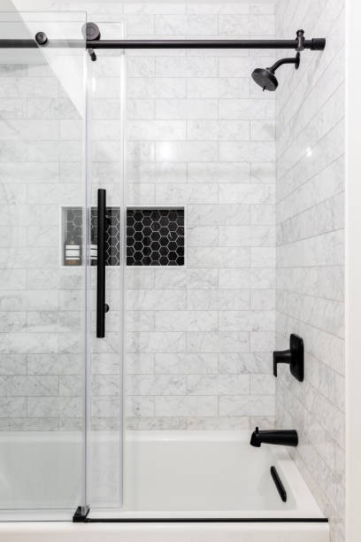 istock A shower with black hexagon and marble tiles. 1454210113