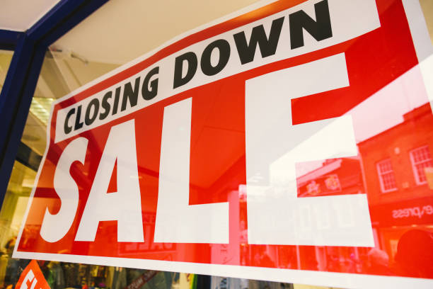 istock Closing down sale sign in store window 1454211849