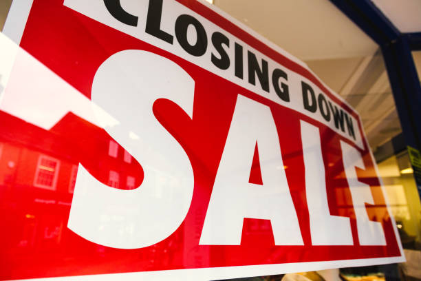 istock Closing down sale sign in store window 1454211875