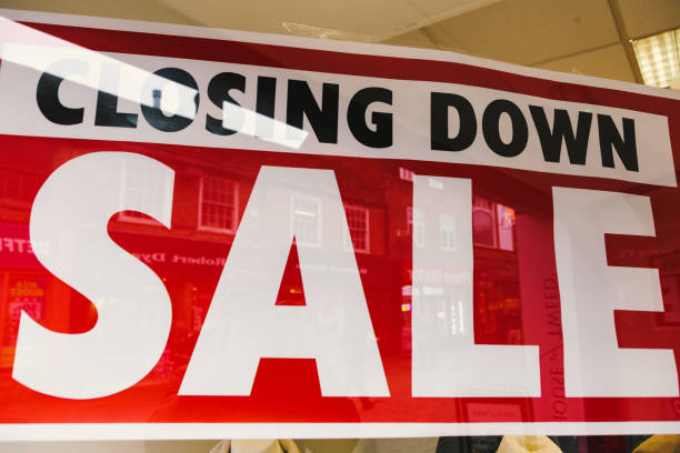 istock Closing down sale sign in store window 1454211888