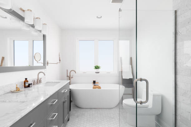 istock A bathroom with a grey cabinet, hexagon tile flooring, and standalone tub. 1454213427