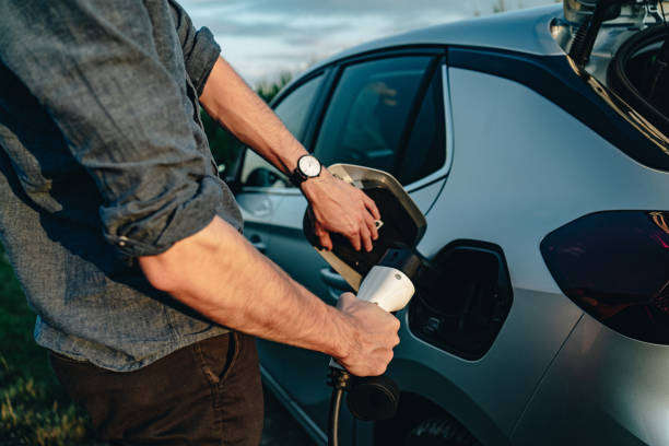 istock Young man recharges electric vehicle 1454213860