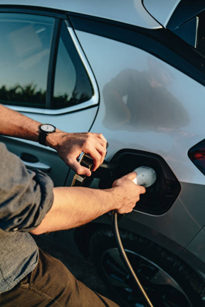 istock Young man recharges electric vehicle 1454213927