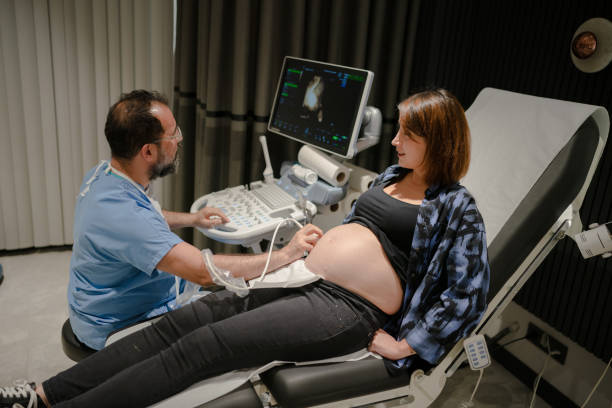 Pregnant woman having ultrasound in gynecology clinic Pregnant woman having ultrasound in gynecology clinic first ultrasound stock pictures, royalty-free photos & images