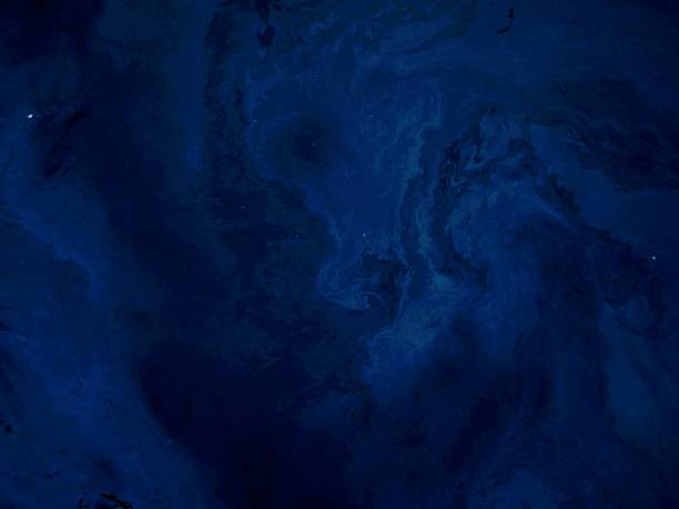 istock Oil slick floating on river water surface at night 1454215422