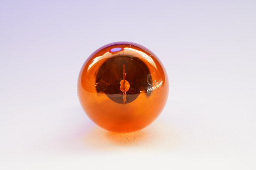 Crystal ball on its own wooden stand, isolated against a white background. 