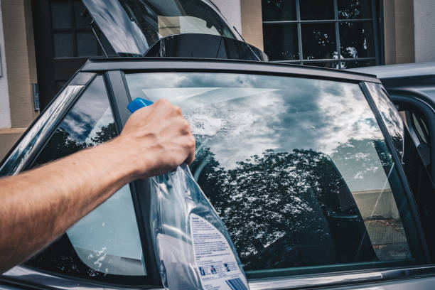 Young man cleans his electric vehicle