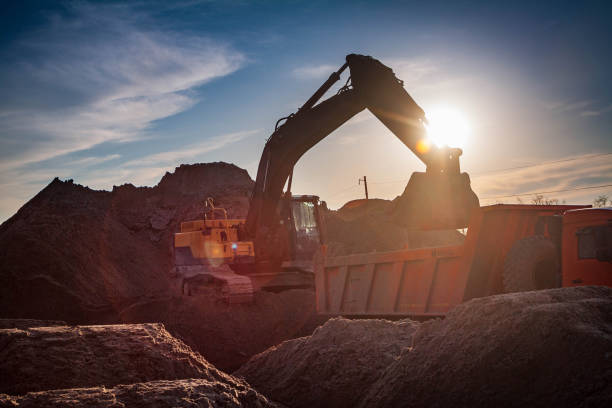 istock Yellow excavator on a construction site against blue sky 1454217477