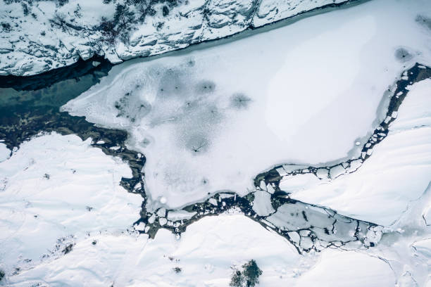istock Blue water and ice in winter. Aerial drone top down view. 1454218725