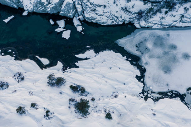 istock Blue water and ice in winter. Aerial drone top down view. 1454218727
