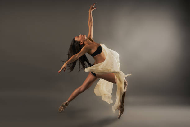 istock Hispanic ballet dancer with black lingerie and gauze covering her doing dance pose 1454219091