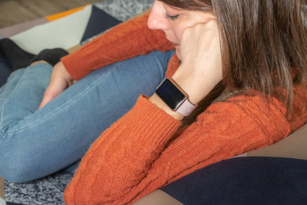 istock girl relaxing on a sofa with her new smartwatch 1454219551