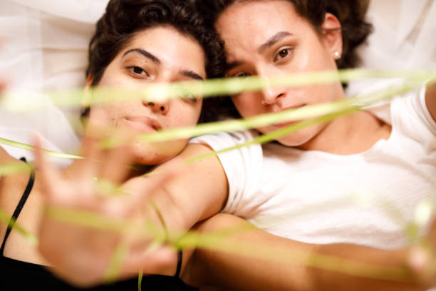 istock Women lying down playing cat's cradle 1454221863