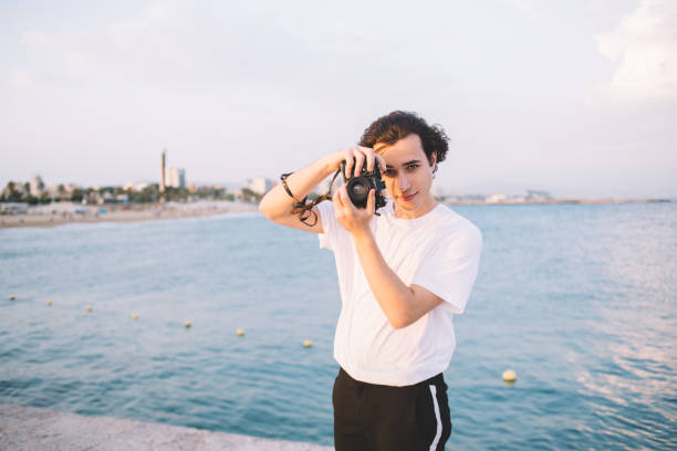 istock Concentrated man photographing on shore 1454223020