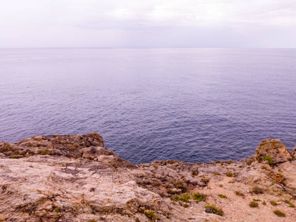 istock View to rocks, sea and cloudy sky 1454223294