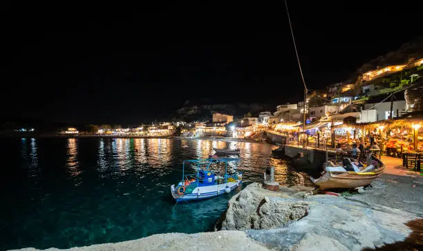 Night view of Matala village restaurants in Crete, Greece. Nightscape of lights and taverns in the Greek village of Matala, famous for hippies in the 70's.