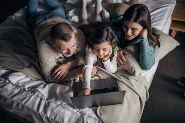 istock Family lying in bed 1454225585