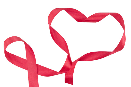 Red heart from a twisted ribbon on a white isolated background. Valentine's Day. Copy space