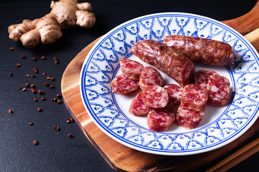 Food concept Sweet Chinese sausage Lap cheong in asia style plate on wooden board with copy space