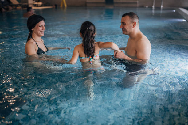 istock Family in hotel swimming pool 1454232745