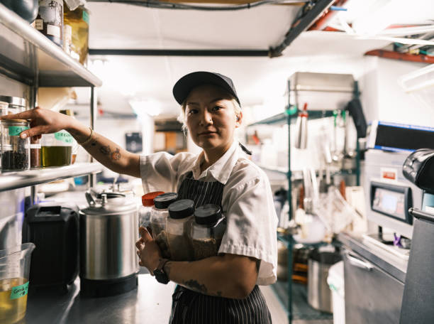 istock Young Korean female chef working in restaurant kitchen 1454233063