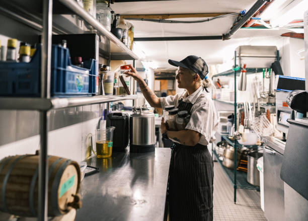 istock Young Korean female chef working in restaurant kitchen 1454233098