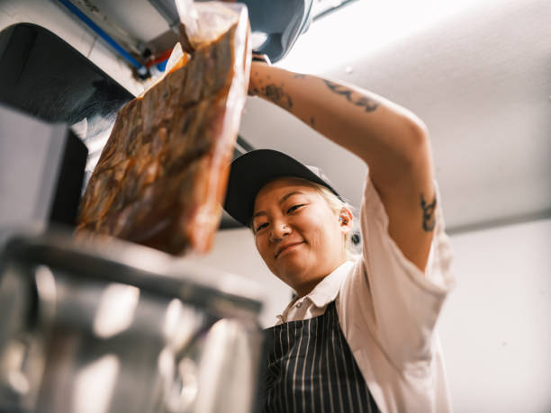 istock Young Korean female chef working in restaurant kitchen 1454233231