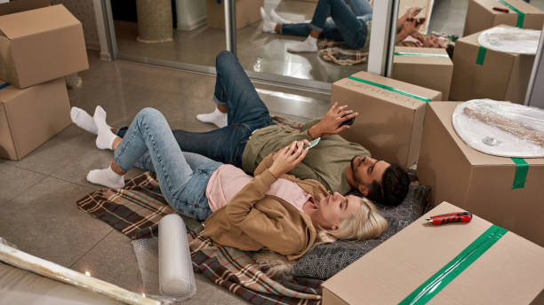 istock High angle of couple using smartphones on blanket 1454233303