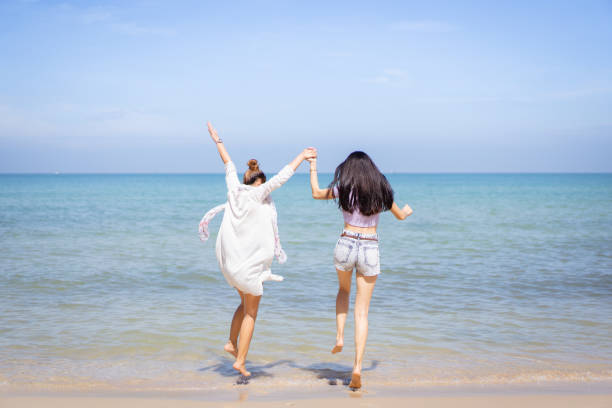 istock Women walking at the beach. 1454233958