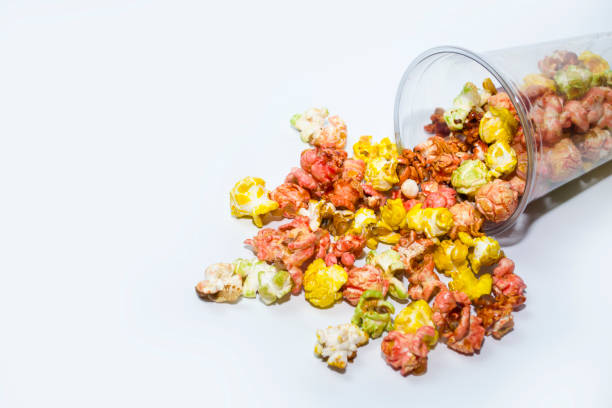 istock Popcorn poured out of the cup on a white background. 1454234000
