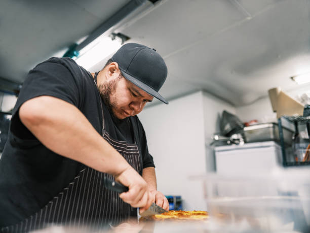 istock Young Mexican male chef working in restaurant kitchen 1454234018
