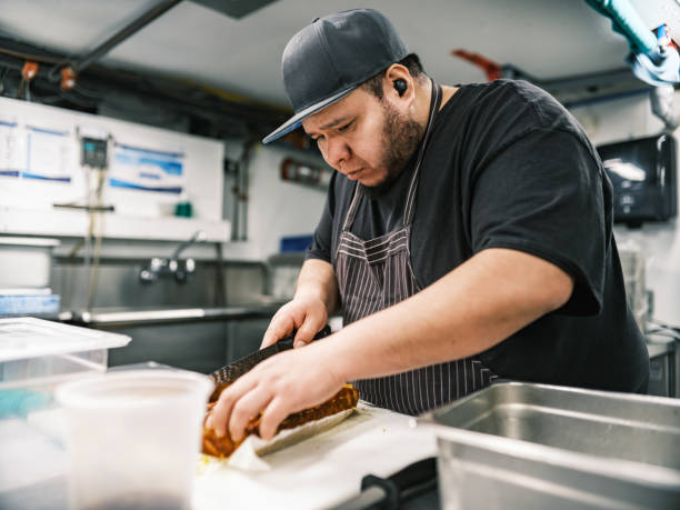 istock Young Mexican male chef working in restaurant kitchen 1454234032