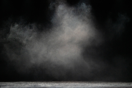 Dry white ice smoke clouds fog empty stage textured. Isolated black background