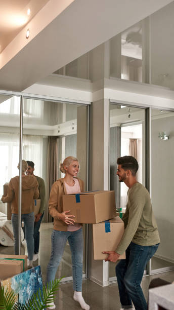 istock Multiracial couple carrying boxes in new apartment 1454235385