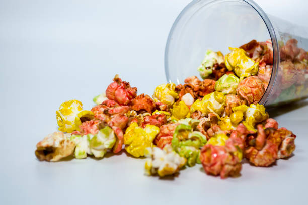 istock Popcorn poured out of the cup on a white background. 1454235655