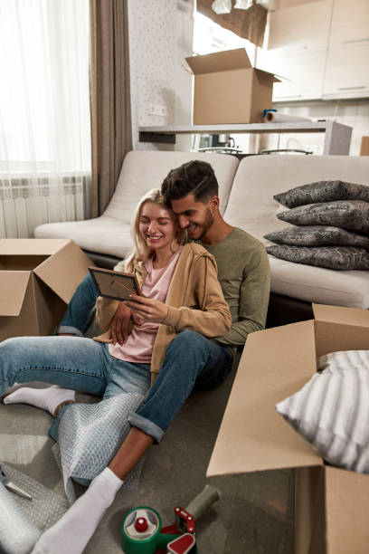 istock Multiethnic couple rest and look photo on floor 1454236965
