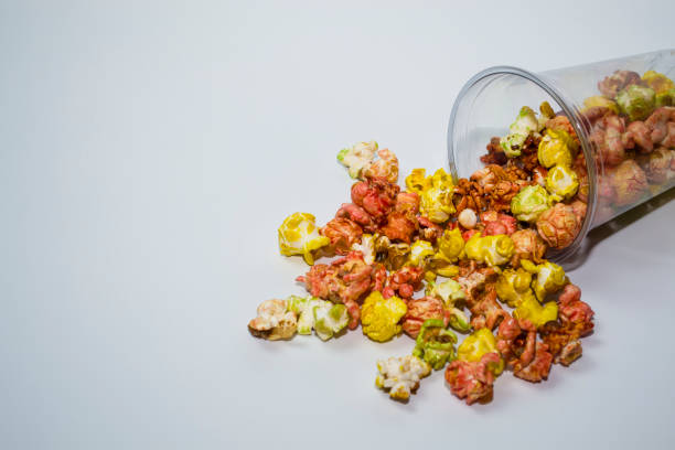 istock Popcorn poured out of the cup on a white background. 1454237702