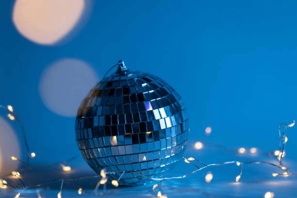 istock Christmas blue background with disco ball and garland. 1454239254