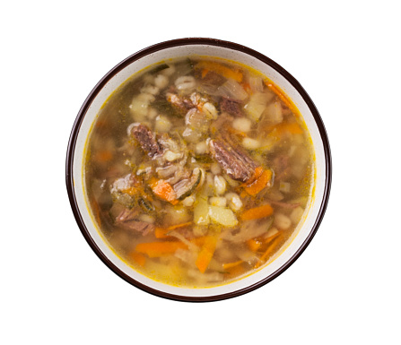 Traditional Russian soup with pickled cucumbers. Pickle with pearl barley and meat on a white isolated background. Top view
