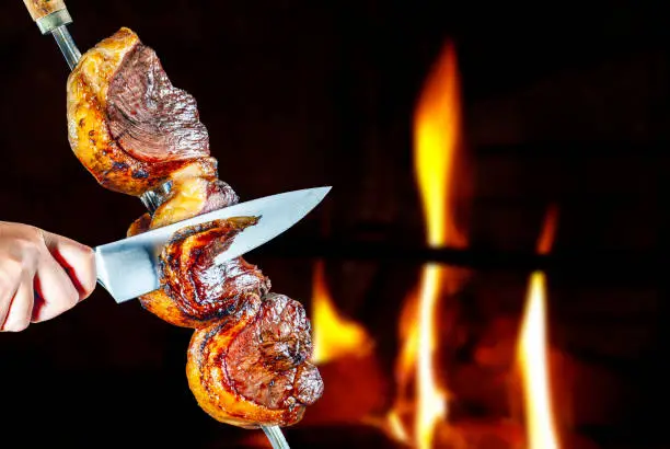 Photo of Steak rotisserie at the steakhouse, sliced picanha, Picanha
